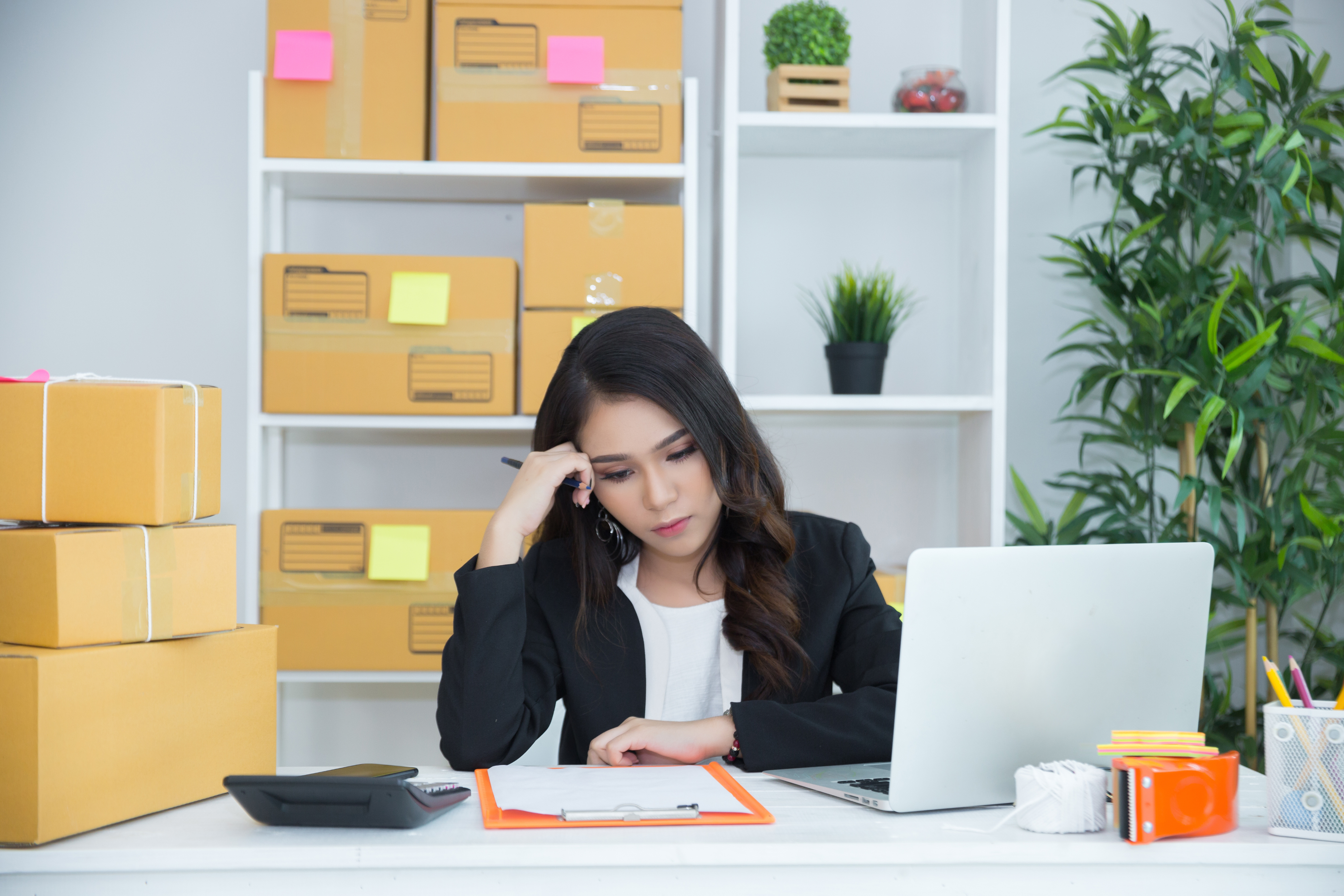 Woman at desk looking at laptop