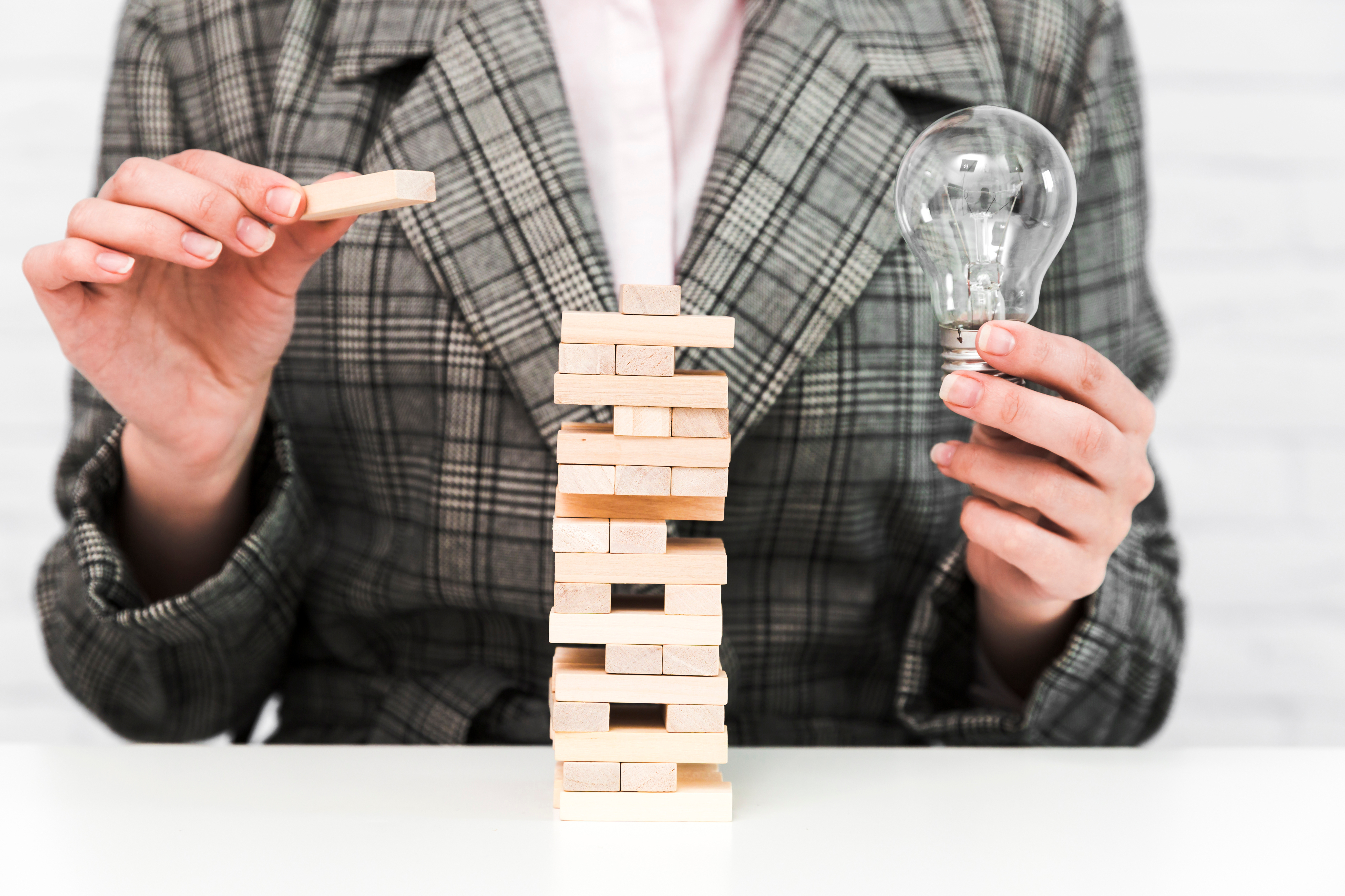 Business strategy with Jenga blocks and a lightbulb
